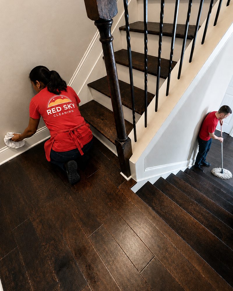 A cleaner hand-wiping stair treads and skirting.