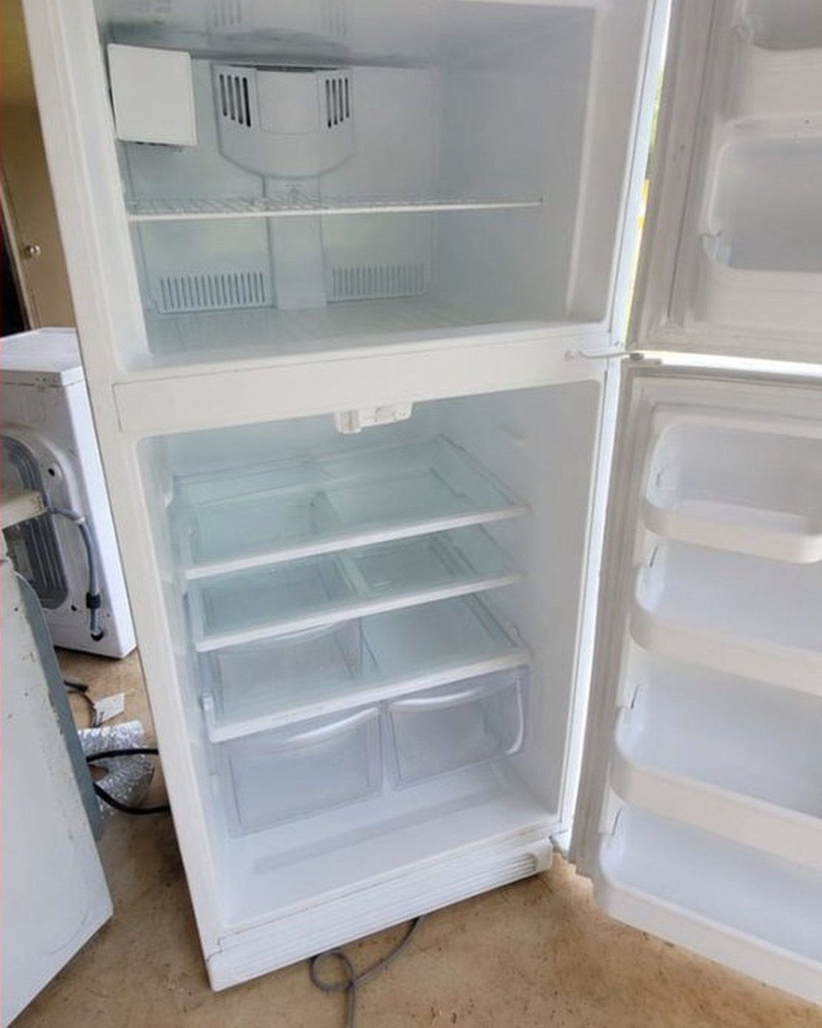 The same refrigerator after cleaning, every shelf and seal back to bare white.